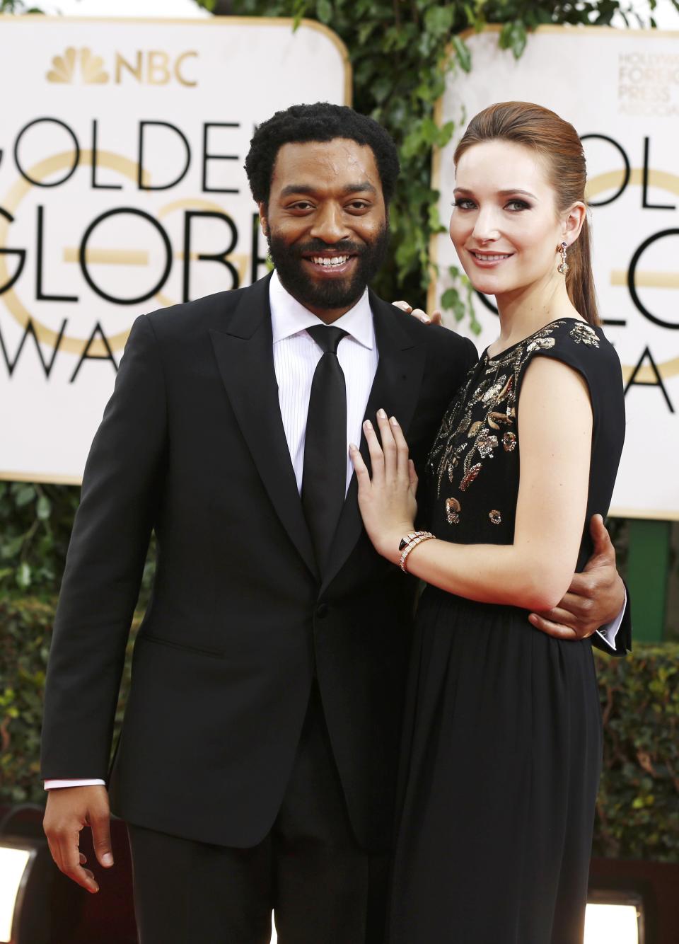 Actor Chiwetel Ejiofor from the film "12 Years a Slave" arrives with Sari Mercer at the 71st annual Golden Globe Awards in Beverly Hills