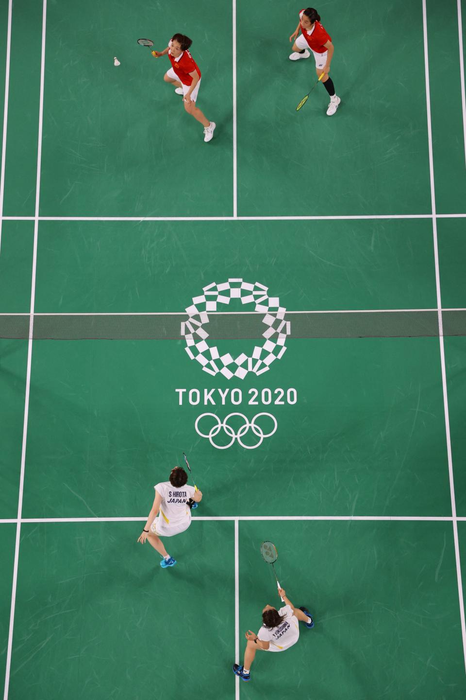 <p>China's Chen Qingchen (top L) hits a shot next to China's Jia Yifan in their women's doubles badminton quarter final match against Japan's Yuki Fukushima and Japan's Sayaka Hirota during the Tokyo 2020 Olympic Games at the Musashino Forest Sports Plaza in Tokyo on July 29, 2021. (Photo by LINTAO ZHANG / POOL / AFP) (Photo by LINTAO ZHANG/POOL/AFP via Getty Images)</p> 