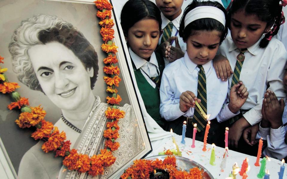 School children light candles in tribute to Indira Gandhi, the late former Indian prime minister, on the occasion of her 23rd death anniversary