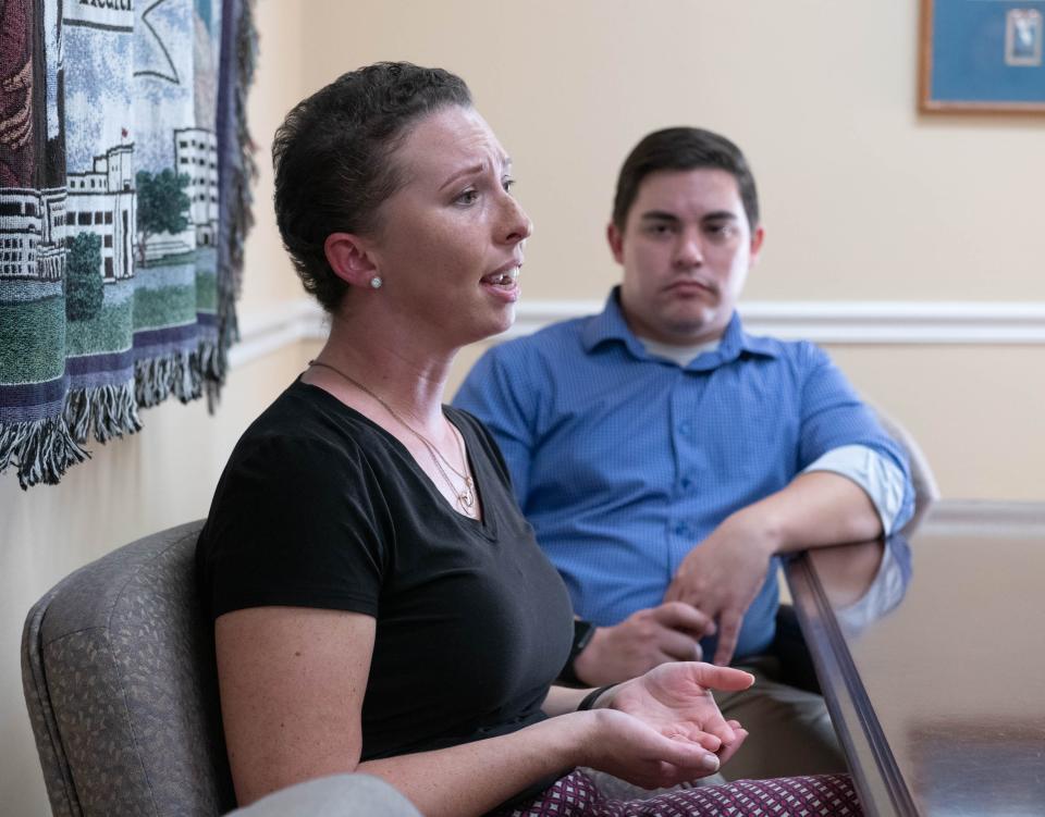 Josiah Burdick, right, listens as his wife Whitney Burdick talks about her battle with breast cancer at Ascension Sacred Heart Hospital in Pensacola on Friday, Oct. 20, 2023.