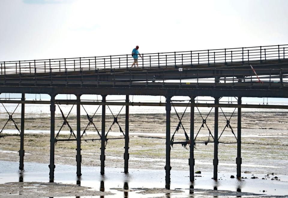 A person enjoys a walk along Southend Pier (PA) (PA Archive)