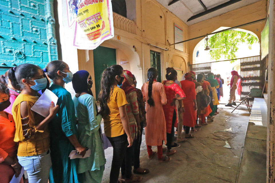 Rajasthan Basic School Training Course (BSTC) students stand outside a centre to appear for the exams amid the ongoing coronavirus pandemic, in Jaipur, Rajasthan, India, on August 31, 2020. (Photo by Vishal Bhatnagar/NurPhoto via Getty Images)