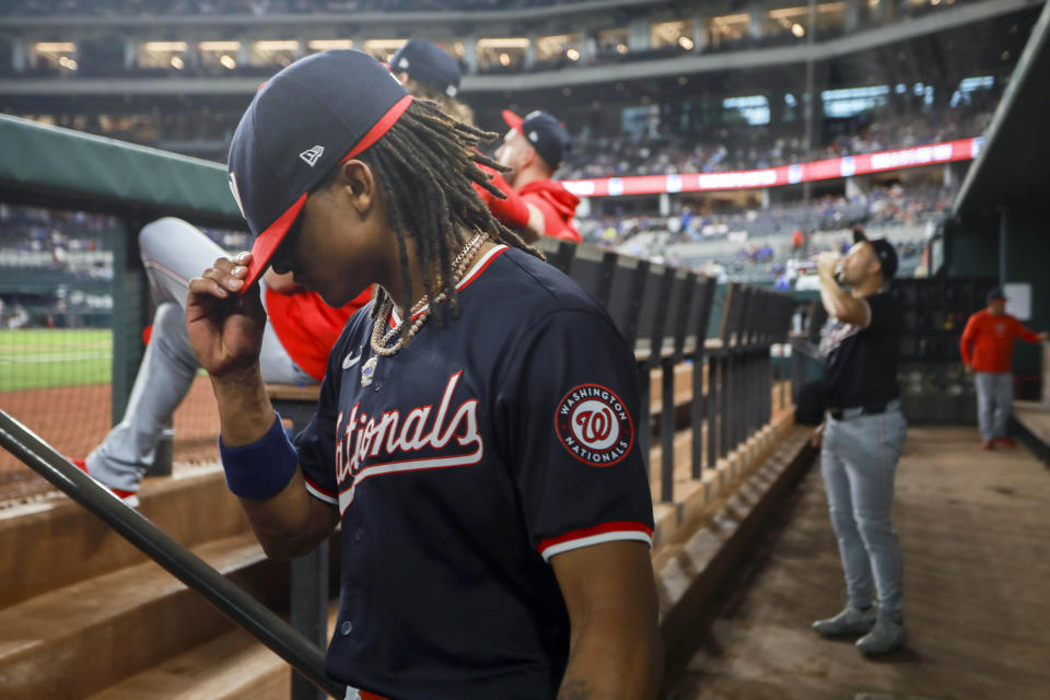 Washington Nationals shortstop CJ Abrams pulls his hat down as he walks onto the field before a baseball game against the Texas Rangers in Arlington, Texas, Wednesday, May 1, 2024. (AP Photo/Gareth Patterson)