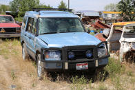 <p>Judging by the scrapes on the hood, roof and side, this misshapen Land Rover Discovery has clearly rolled. How on earth did those roof bars manage to stay on during the accident?</p><p>It’s a facelifted Discovery Series 2, which is easily identified by its larger headlamps. </p><p>These were manufactured between 2002 and 2004, so it’s easily the newest car we spotted in the yard. If Jim’s International yard truck ever gives up the ghost, we reckon this might make a good replacement. Another vehicle from<strong> Jim’s Vintage Automotive, Idaho.</strong></p>