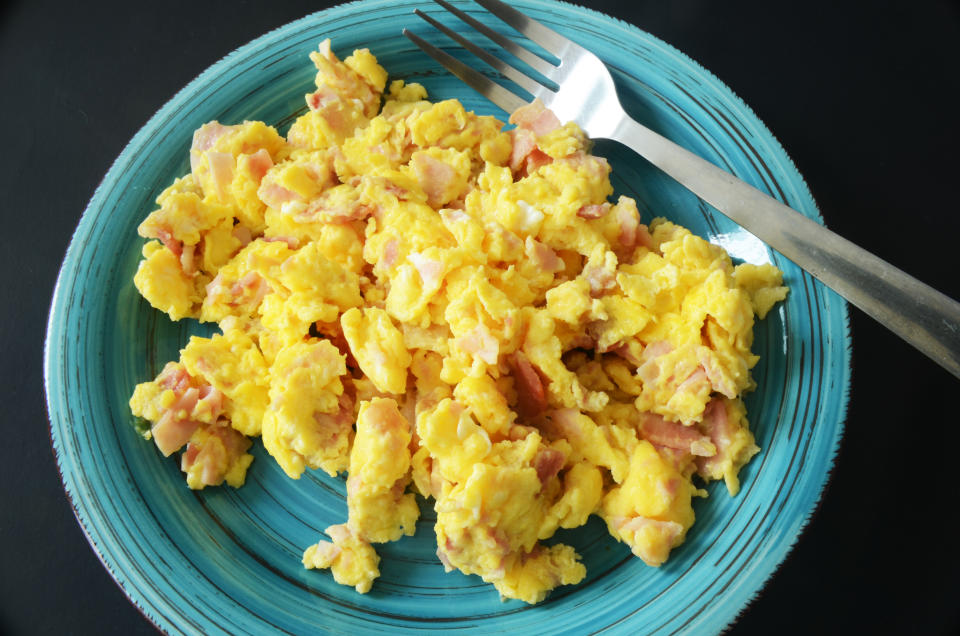 close up of scramble eggs with ham breakfast