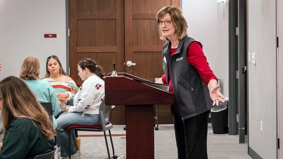 Laura Reyher, WT's Baptist Community Services Professor of Rural Health, explains the rules of the poverty simulation to senior nursing students in Harrington Academic Hall WTAMU Amarillo Center.