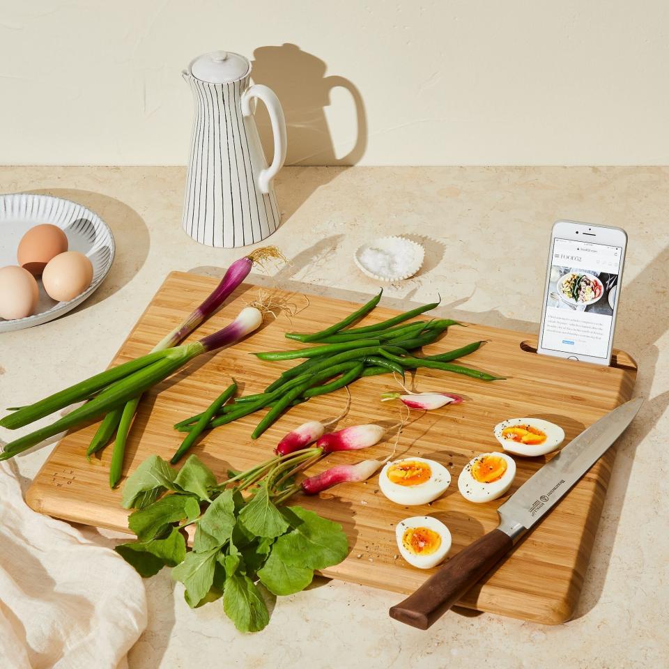 If she's always finding new recipes online, this cutting board has some space for her phone. <a href="https://fave.co/2JvroDm" target="_blank" rel="noopener noreferrer">Find it for $59 at Food52</a>.