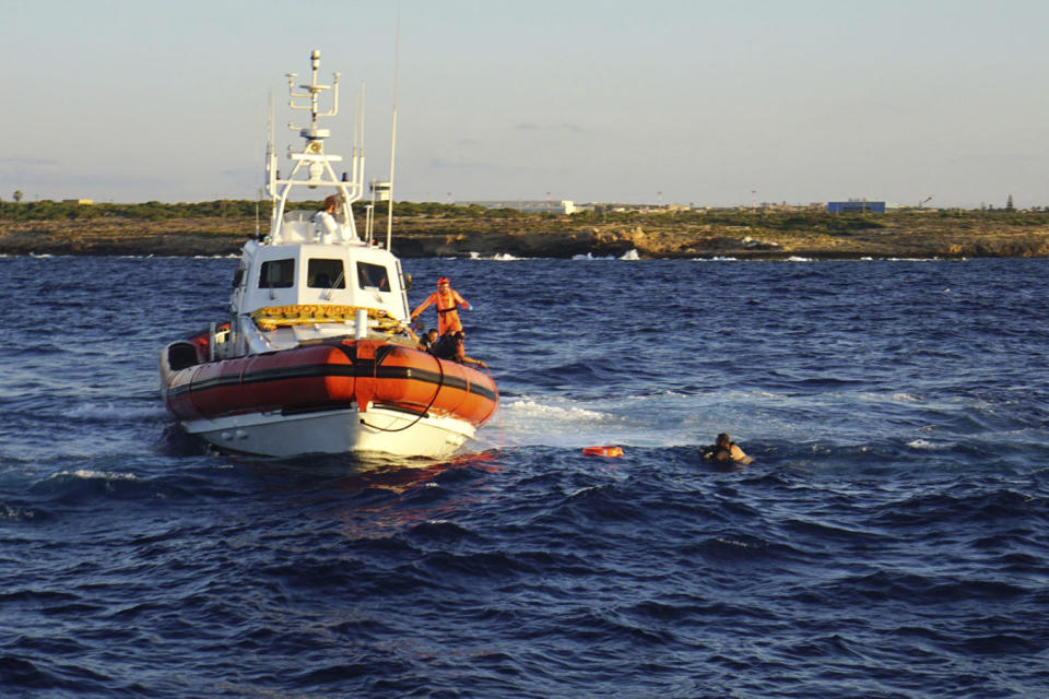 A man who threw himself in the water from the Open Arms vessel, is intercepted by the Italian Coast guards as he tried to swim to the island of Lampedusa, southern Italy, Tuesday, Aug. 20, 2019. The Spanish humanitarian rescue ship Open Arms says another man had to be rescued after jumping in the sea as the stand-off with Italy, which won't permit it access to a port, entered its 19th day. Open Arms described the situation on board Tuesday as ''desperate,'' saying that a man threw himself in the water trying to reach trying to reach land in plain view, while at the same moment a woman suffered a panic attack. (AP Photo/Francisco Gentico)