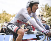 Slovenia's Tadej Pogacar wins and takes the overall leader's yellow jersey as he crosses the finish line of stage 20 of the Tour de France cycling race, an individual time trial over 36.2 kilometers (22.5 miles), from Lure to La Planche des Belles Filles, France, Saturday, Sept. 19, 2020. (Marco Bertorello/Pool via AP)