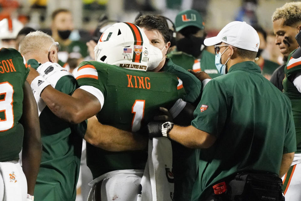 Miami quarterback D'Eriq King (1) is taken off the field after he was injured during the first half of the Cheez-it Bowl NCAA college football game against Oklahoma State, Tuesday, Dec. 29, 2020, in Orlando, Fla. (AP Photo/John Raoux)