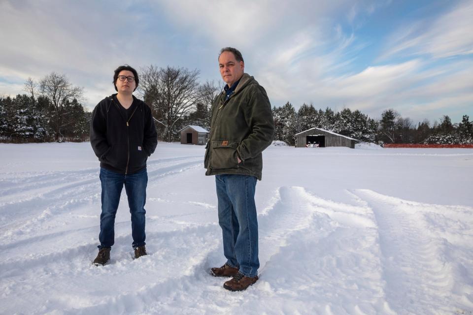 Robin Chan, left, and John Wisely, an audio producer and reporter with the Detroit Free Press, stand on the snow early morning in Newberry on Thursday, Nov. 30, 2023.