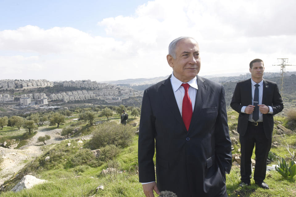 Israeli Prime Minister Benjamin Netanyahu stands at an overview of the West Bank Israeli settlement of Har Homa where he announced a new neighborhood is to be built, Thursday, Feb. 20, 2020. (Debbie Hill/Pool via AP)