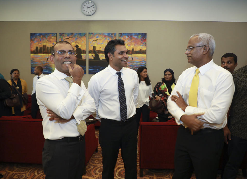Maldives’ former president Mohamed Nasheed, left chats with president elect Ibrahim Mohamed Solih, right and vice president elect Faisal Naseem, upon arrival at airport in Maldives, Thursday, Nov.1, 2018. Nasheed, the first democratically elected president of the Maldives returned home Thursday after more than two years in exile to escape a long prison term. (AP Photo/Mohamed Sharuhaan)
