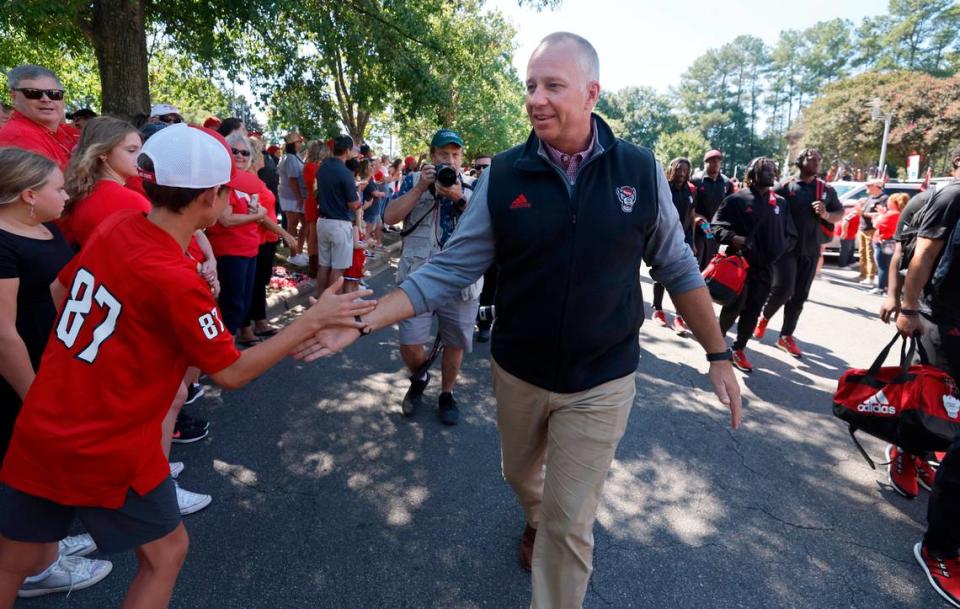 N.C. State head coach Dave Doeren greets fans during the Walk of Champions before N.C. State’s game against VMI at Carter-Finley Stadium in Raleigh, N.C., Saturday, Sept. 16, 2023. Ethan Hyman/ehyman@newsobserver.com