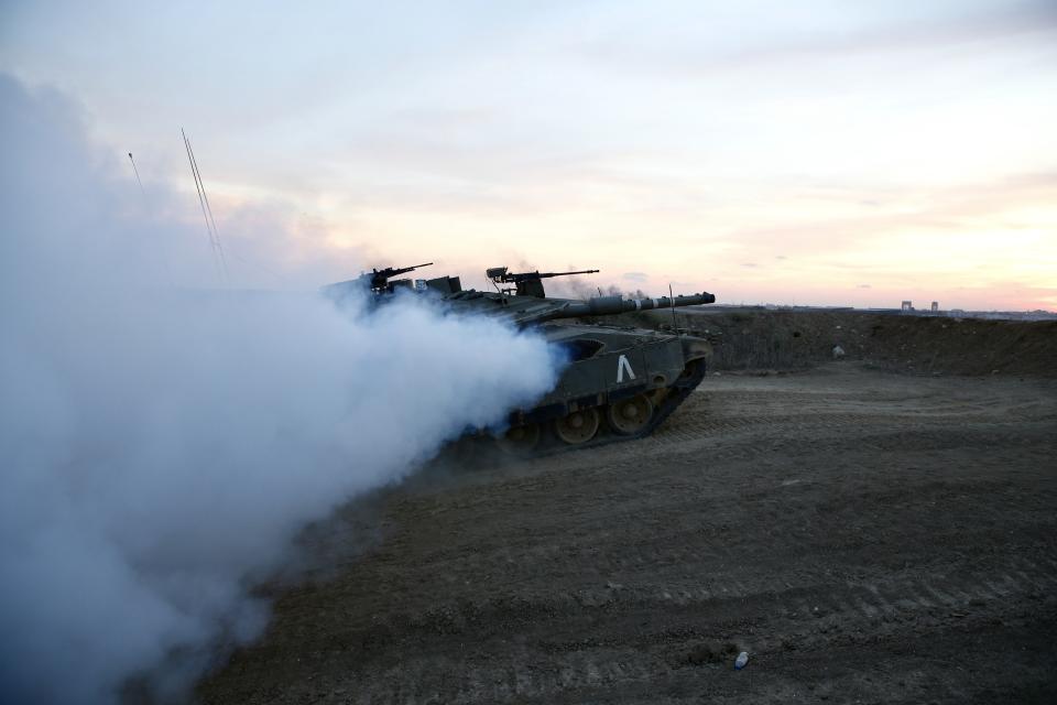 An Israeli tank is seen near the in Israel and Gaza border, Israel, Friday, Oct. 5, 2018. The Israeli military said Thursday it was bolstering its forces along the Gaza border ahead of another expected explosive Hamas-orchestrated protest. (AP Photo/Ariel Schalit)