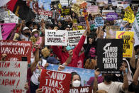 Protesters shout slogans during a rally as they commemorate International Human Rights Day, Saturday, Dec. 10, 2022, near the Malacanang presidential palace in Manila, Philippines. Hundreds of people marched in the Philippine capital on Saturday protesting what they said was a rising number of extrajudicial killings and other injustices under the administration of President Ferdinand Marcos Jr. (AP Photo/Aaron Favila)