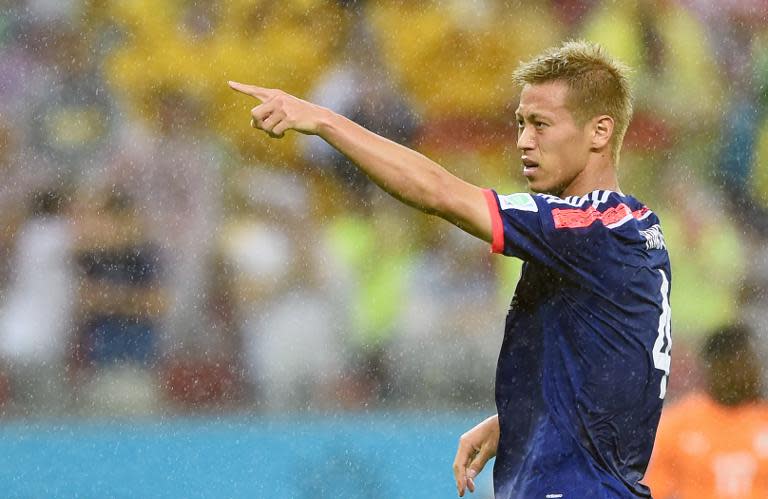 Japan's Keisuke Honda celebrates after scoring a goal during their Group C match against Ivory Coast, at the Pernambuco Arena in Recife, during the FIFA World Cup, on June 14, 2014