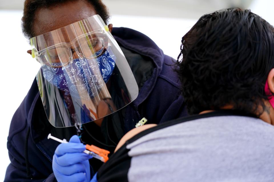 Hamilton County Public Health Nurse Cora McGuire administers a COVID-19 vaccine on May 10 at Yorktowne Mobile Home Park in Sharonville, Ohio.