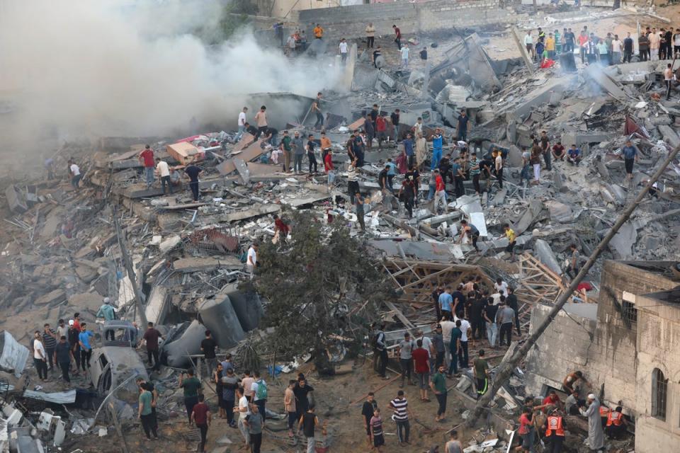 Palestinians inspect the damage of destroyed buildings following Israeli airstrikes on Gaza City, (Copyright 2023 The Associated Press. All rights reserved.)