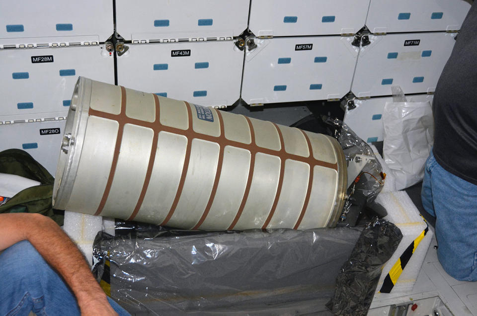 A waste water tank, which was removed from the space shuttle Endeavour in August 2015, is seen being reinstalled inside the retired orbiter in August 2016.