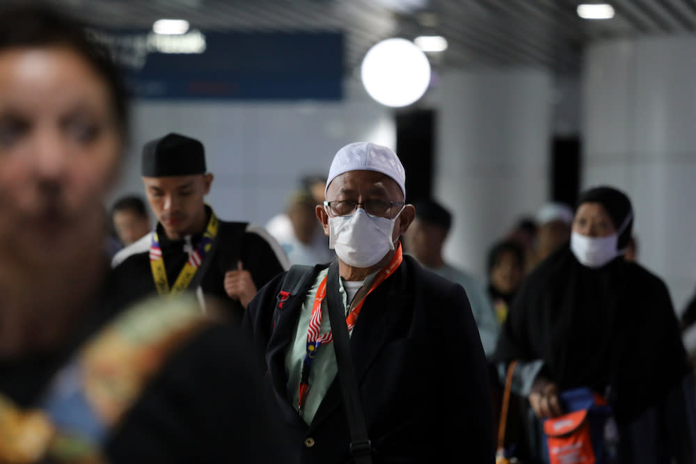 A passenger wears a mask at Kuala Lumpur International Airport in Sepang January 21, 2020. — Reuters pic