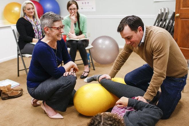 In 2017, Catie Mehl, front left, instructs Todd Gable of Columbus how to help ease wife Erika's labor pains when the time comes for their baby to be born. Fellow doulas Kirsten Pitini, back left, and Janetta Schumacher watch the demonstration at Columbus Birth and Parenting in Worthington.
