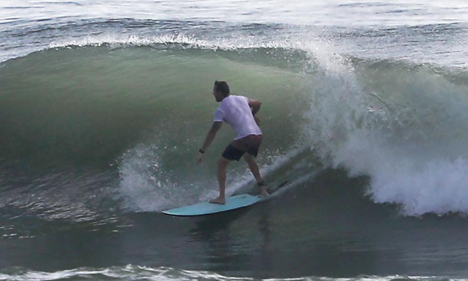 A surfer catches a wave, Tuesday August 29, 2023 near Dahila Park in Daytona Beach Shores.
