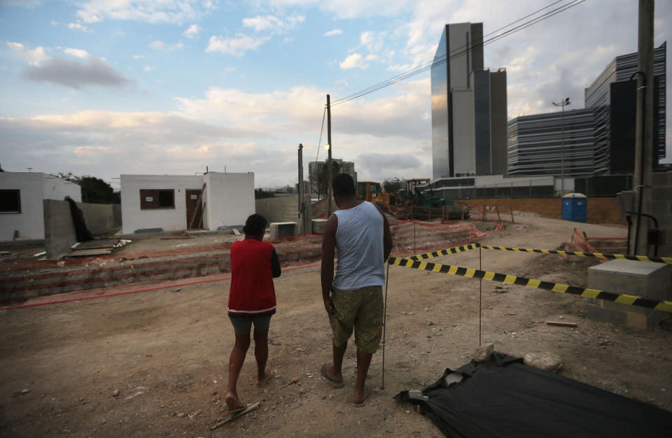 <p>Holdout Suely Ferreira Campos (L) and her son Fabio walk near what will be her new home (L) in the Vila Autodromo 'favela’ community next to the Olympic Park ® in the Barra da Tijuca neighborhood on July 16, 2016 in Rio de Janeiro, Brazil. (Mario Tama/Getty Images)</p>