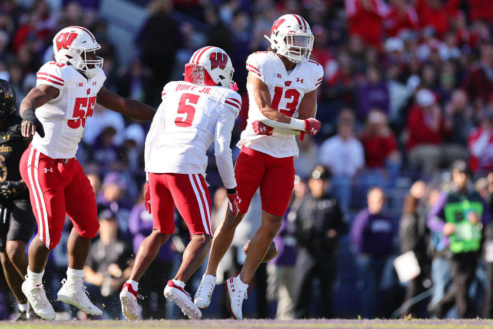 Kamo’i Latu #13 of the Wisconsin Badgers celebrates after intercepting a pass from <a class="link " href="https://sports.yahoo.com/ncaaf/players/299058" data-i13n="sec:content-canvas;subsec:anchor_text;elm:context_link" data-ylk="slk:Ryan Hilinski;sec:content-canvas;subsec:anchor_text;elm:context_link;itc:0">Ryan Hilinski</a> #3 of the <a class="link " href="https://sports.yahoo.com/ncaaf/teams/northwestern/" data-i13n="sec:content-canvas;subsec:anchor_text;elm:context_link" data-ylk="slk:Northwestern Wildcats;sec:content-canvas;subsec:anchor_text;elm:context_link;itc:0">Northwestern Wildcats</a> (not pictured) during the first half at Ryan Field on Oct. 8, 2022 in Evanston, Illinois. Michael Reaves/Getty Images