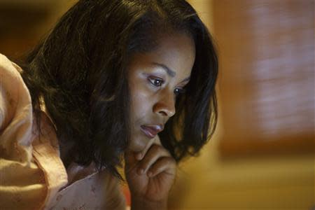 Nita Dittenber checks her Facebook page in her friend's home in Nashville, Tennessee, December 20, 2013. REUTERS/Harrison McClary