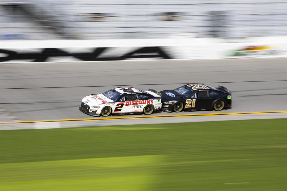 DAYTONA BEACH, FLORIDA - JANUARY 12: Austin Cindric, driver of the #2 Team Penske Ford and Harrison Burton, driver of the #21 Wood Brothers Racing Ford, race during the NASCAR Next Gen Test at Daytona International Speedway on January 12, 2022 in Daytona Beach, Florida. (Photo by James Gilbert/Getty Images) | Getty Images