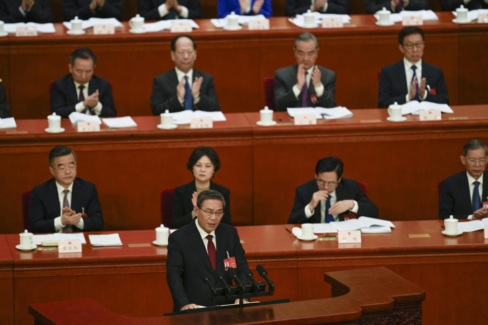 Chinese Premier Li Qiang, center, speaks during the opening session of the National People's Congress (NPC) at the Great Hall of the People in Beijing, China, Tuesday, March 5, 2024. (AP Photo/Ng Han Guan)