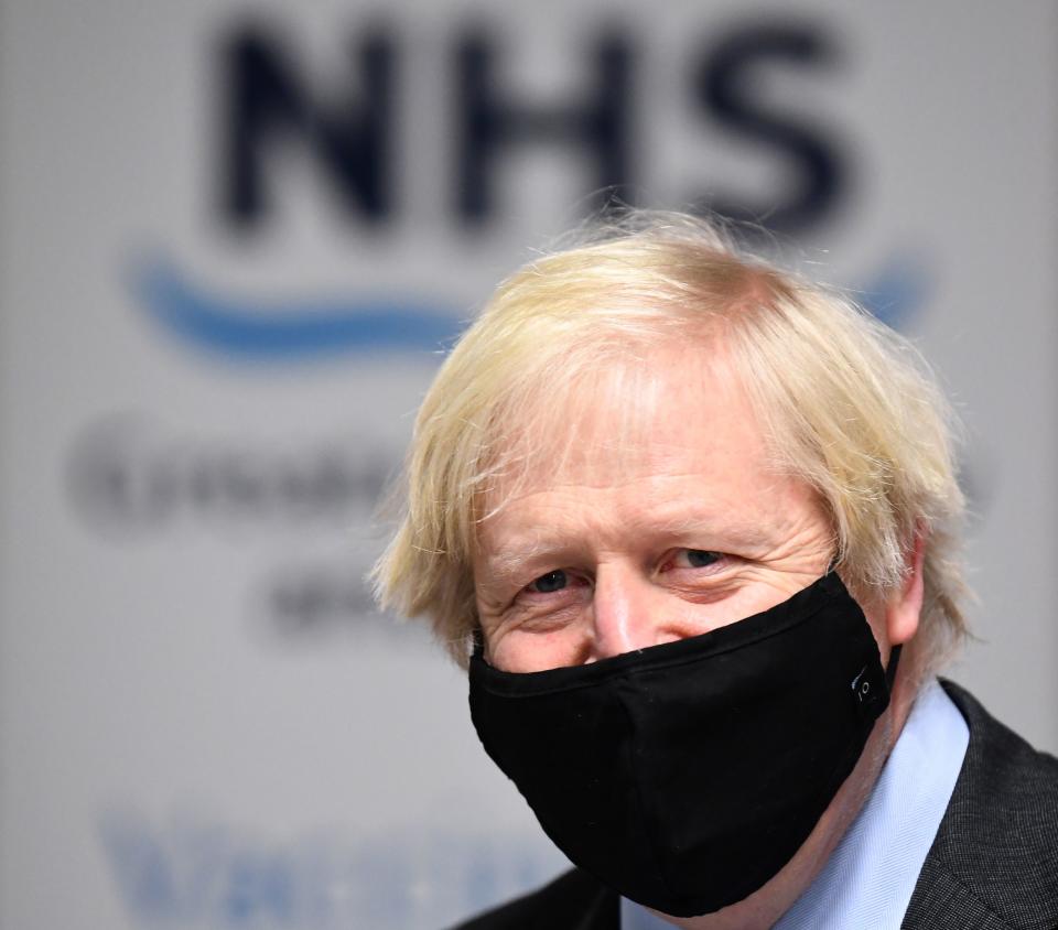 Britain's Prime Minister Boris Johnson meets troops as they set up a vaccination centre in the Castlemilk district in Glasgow, Scotland on January 28, 2021, during a COVID-19 related visit to the country. - Prime Minister Boris Johnson headed to Scotland on Thursday to praise the United Kingdom's collective response to coronavirus, in a bid to counter record support for independence. (Photo by Jeff J Mitchell / POOL / AFP) (Photo by JEFF J MITCHELL/POOL/AFP via Getty Images)