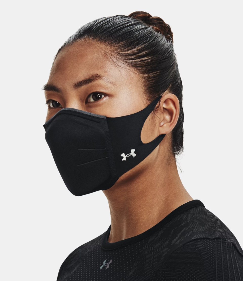 brunette model wearing black under armour face mask and black shirt