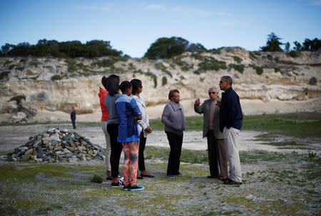 FILE PHOTO: U.S. President Barack Obama is pictured with his family and Ahmed Kathrada, as he visits the rock quarry labor camp where Nelson Mandela was forced to work, while they tour Robben Island near Cape Town, June 30, 2013. REUTERS/Jason Reed/File Photo