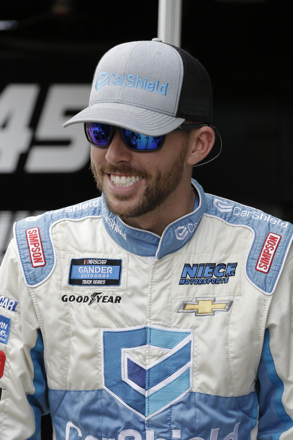 Ross Chastain smiles on pit road before practice for a NASCAR Truck Series auto race on Friday, Nov. 15, 2019, at Homestead-Miami Speedway in Homestead, Fla. Chastain is one of four drivers racing for the series championship. (AP Photo/Terry Renna)