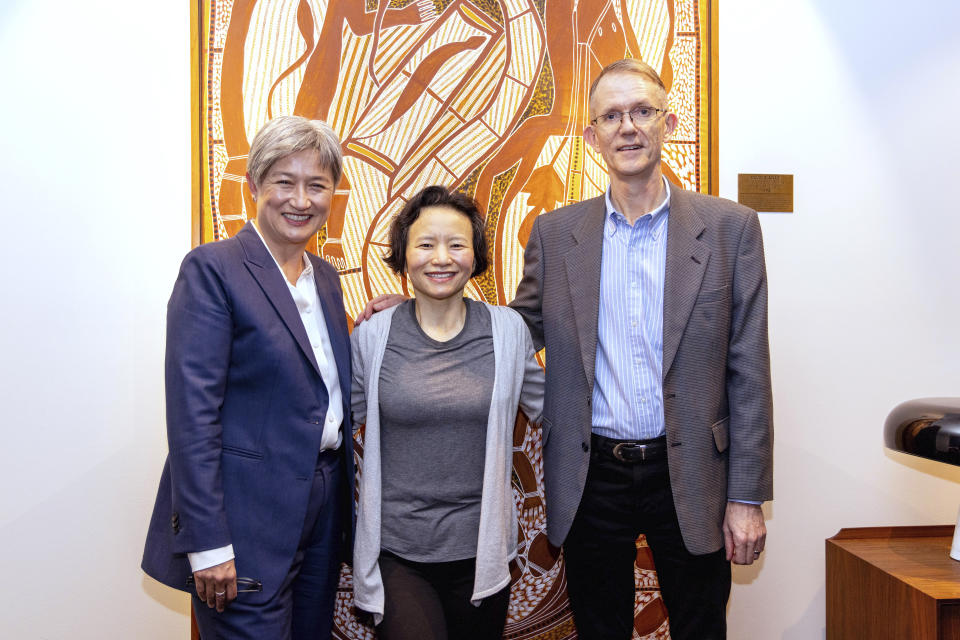 In this photo provided by the Department of Foreign Affairs and Trade, Chinese Australian journalist Cheng Lei, center, posed with Australia's Minister for Foreign Affairs, Penny Wong, and Graham Fletcher, Australian Ambassador to China, right, at Tullamarine Airport in Melbourne, Wednesday, Oct. 11, 2023. Cheng, who was convicted on murky espionage charges and detained in China for three years has returned to Australia. (Sarah Hodges/DFAT via AP)