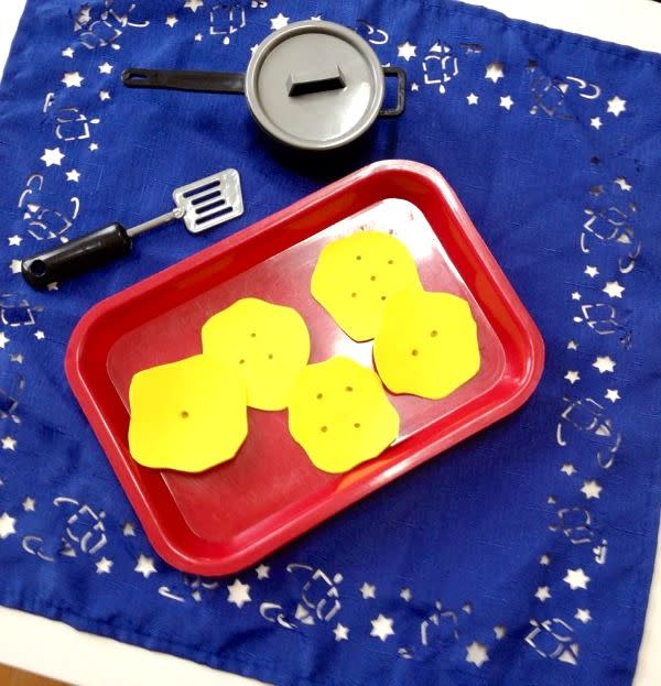<p>Here’s one for the preschoolers in the house. Keep the little ones entertained, and practicing basic math while they’re at it, with this homemade game that gets them excited about counting. Kids can pretend to fry up their own latkes, easily made with craft foam or cardboard, while counting the pretend potato pancakes to the tune of a special song.</p><p><em><a href="https://www.fantasticfunandlearning.com/hanukkah-activities-preschool.html" rel="nofollow noopener" target="_blank" data-ylk="slk:Get the tutorial at Fantastic Fun and Learning »;elm:context_link;itc:0;sec:content-canvas" class="link ">Get the tutorial at Fantastic Fun and Learning »</a></em></p>