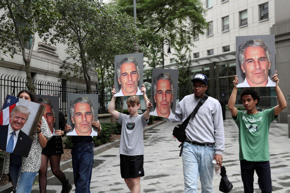 Demonstrators hold signs aloft protesting Jeffrey Epstein, as he awaits arraignment in the Southern District of New York on charges of sex trafficking of minors and conspiracy to commit sex trafficking of minors, in New York, U.S., July 8, 2019. REUTERS/Shannon Stapleton     TPX IMAGES OF THE DAY