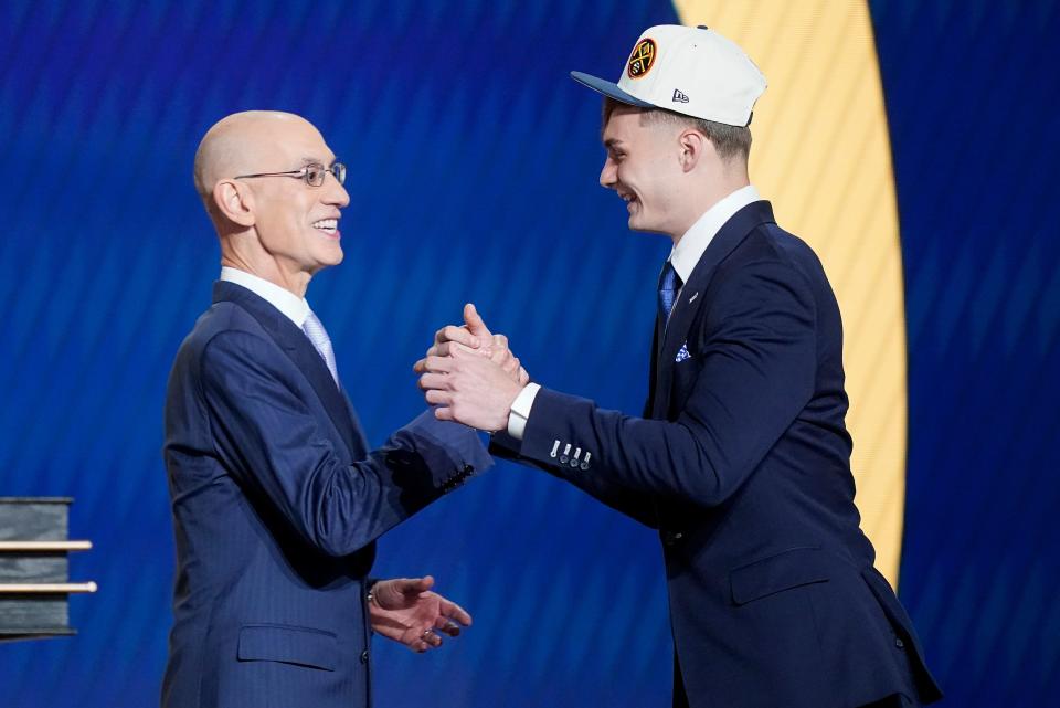 Christian Braun, right, is congratulated by NBA Commissioner Adam Silver after being selected 21st overall by the Denver Nuggets in the NBA draft on June 23, 2022, in New York. Braun spent his collegiate career at Kansas.