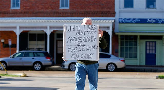 A man, who refused to be identified, pickets outside the bond hearing for Derrick Stafford. Photo: AP