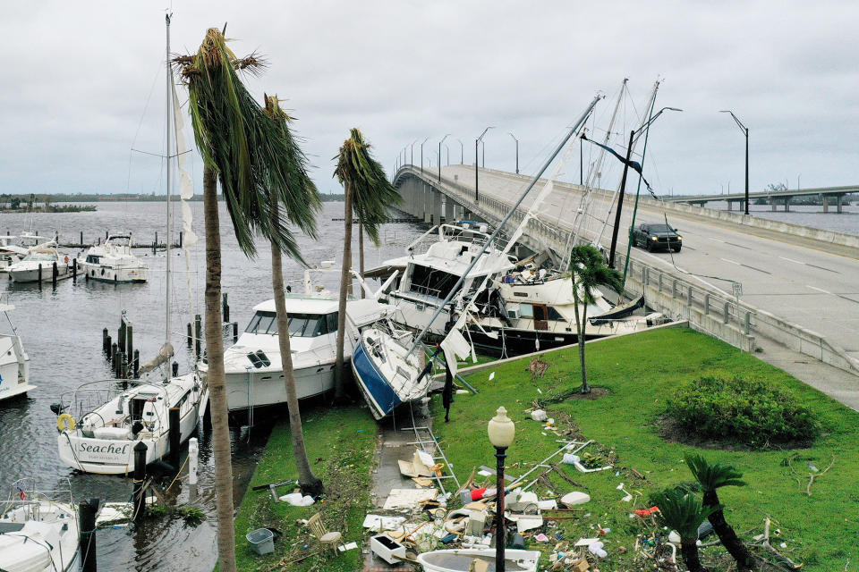 Boats are pushed up on a causeway after Hurricane Ian passed through the area in Fort Myers, on Sept. 29, 2022.