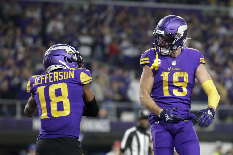 Minnesota Vikings wide receiver Adam Thielen (19) celebrates with teammate wide receiver Justin Jefferson (18) after catching a 15-yard touchdown pass during the second half of an NFL football game against the New England Patriots, Thursday, Nov. 24, 2022, in Minneapolis. (AP Photo/Andy Clayton-King)