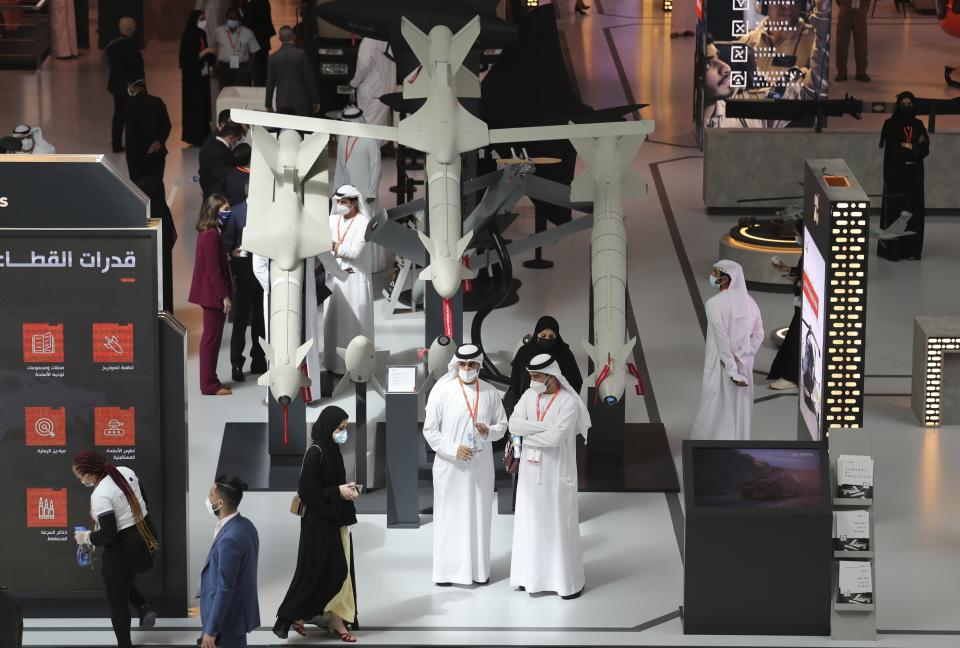 A military delegation visit the display of Halcon, a regional leader in the end-to-end manufacturing of precision-guided systems, during the opening day of the International Defence Exhibition & Conference, IDEX, in Abu Dhabi, United Arab Emirates, Sunday, Feb. 21, 2021. (AP Photo/Kamran Jebreili)