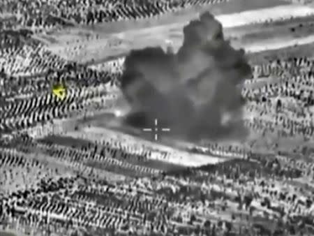 A frame grab taken from footage released by Russia's Defence Ministry October 3, 2015, shows smoke rising after airstrikes carried out by Russian air force on what Russia says was a bomb factory in Maarat al-Numan, south of the town of Idlib, Syria. REUTERS/Ministry of Defence of the Russian Federation/Handout via Reuters
