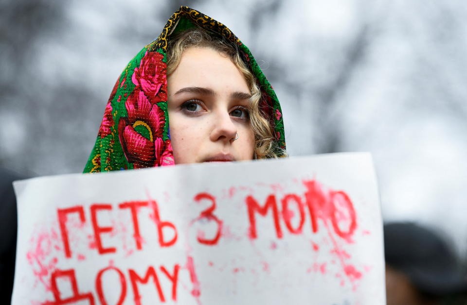 The invasion of Ukraine: A demonstrator displays a placard during a protest against Russia's attack on Ukraine, outside the Dutch parliament in The Hague, Netherlands, on 24 February. Photo: Piroschka van de Wouw/Reuters