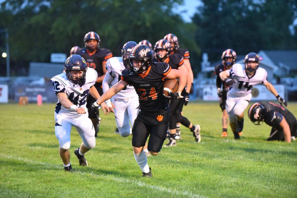 Hudson's Beckett McCaskey carries the ball during Friday's game against Hillsdale.