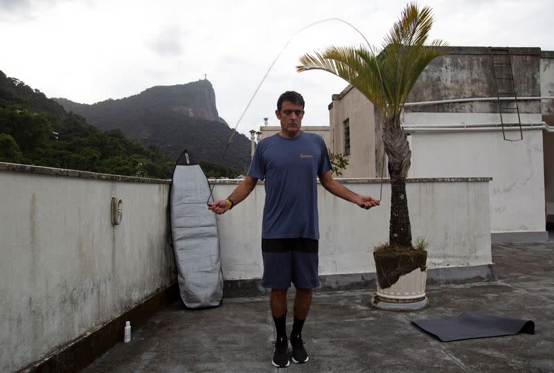 Surfer Bruno Bocayuva exercises on the rooftop of his apartment complex, amid the coronavirus disease (COVID-19) outbreak, in Rio de Janeiro