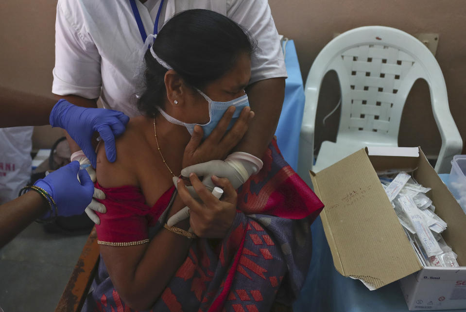 A hospital staff receives a COVID-19 vaccine at a government Hospital in Hyderabad, India, Friday, Jan. 22, 2021. India kicked off its massive vaccination drive on Jan. 16, with a goal of inoculating 300 million of its nearly 1.4 billion people. (AP Photo/Mahesh Kumar A.)
