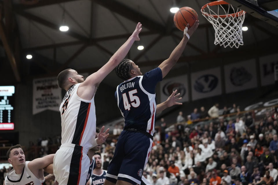 Gonzaga guard Rasir Bolton (45) shoots while defended by Pacific guard Judson Martindale, left, during the first half of an NCAA college basketball game in Stockton, Calif., Saturday, Jan. 21, 2023. (AP Photo/Godofredo A. Vásquez)